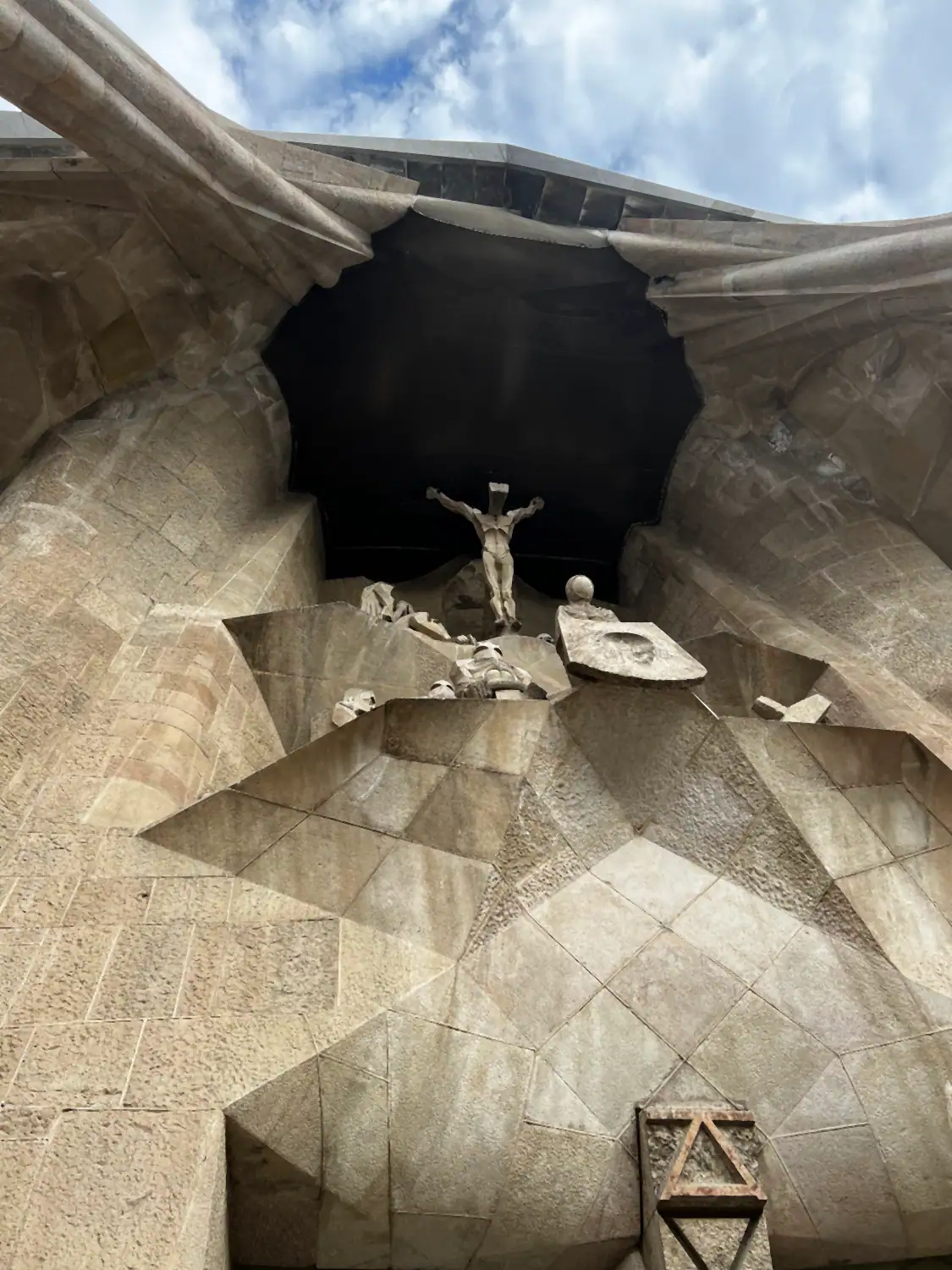 A vaulted stone ceiling with a carved star-shaped boss and a hanging light.