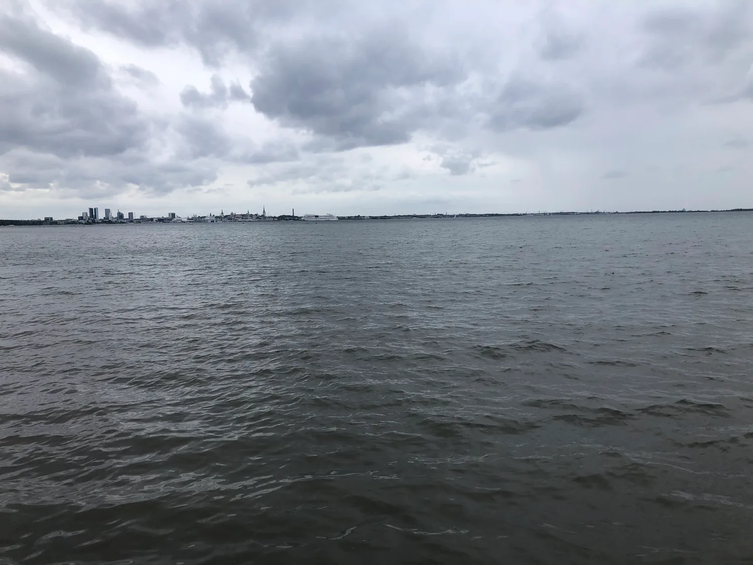 Open water running to the horizon under cloud.