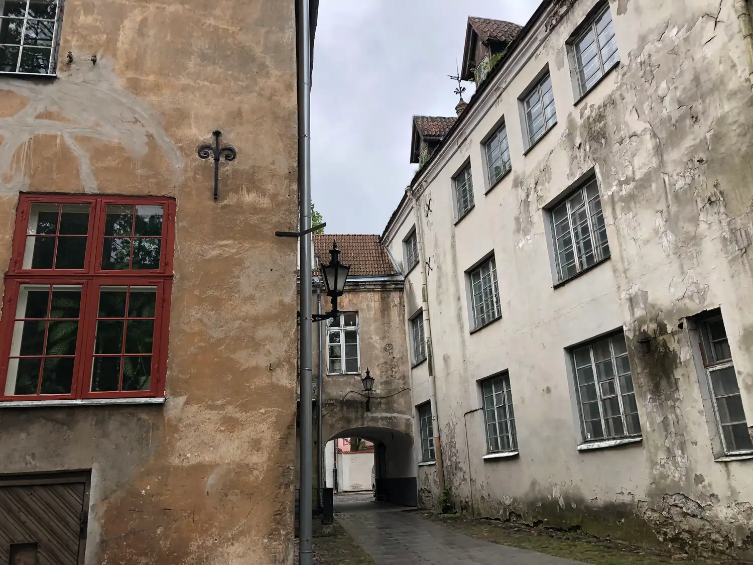 An old town street of tall houses seen from a doorway.